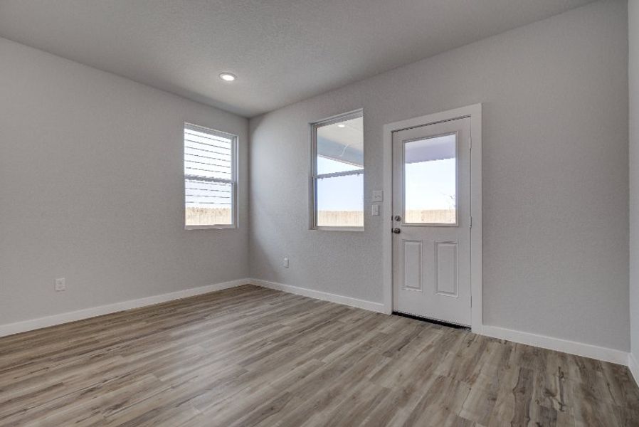 A room with a wood floor and a white door.