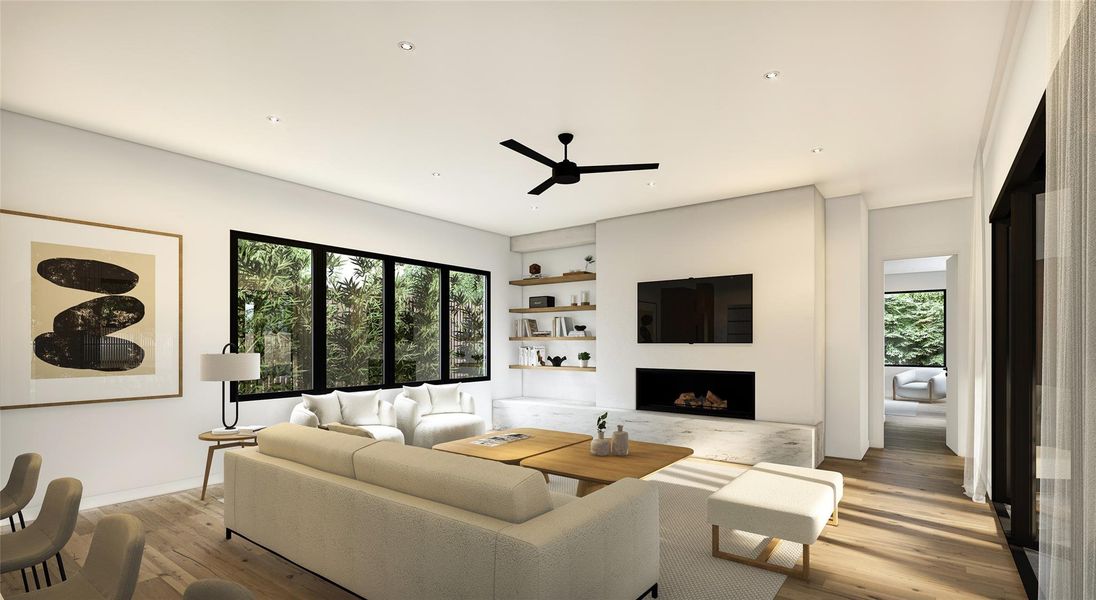 Living room with ceiling fan, plenty of natural light, light wood finished floors, and built in shelves