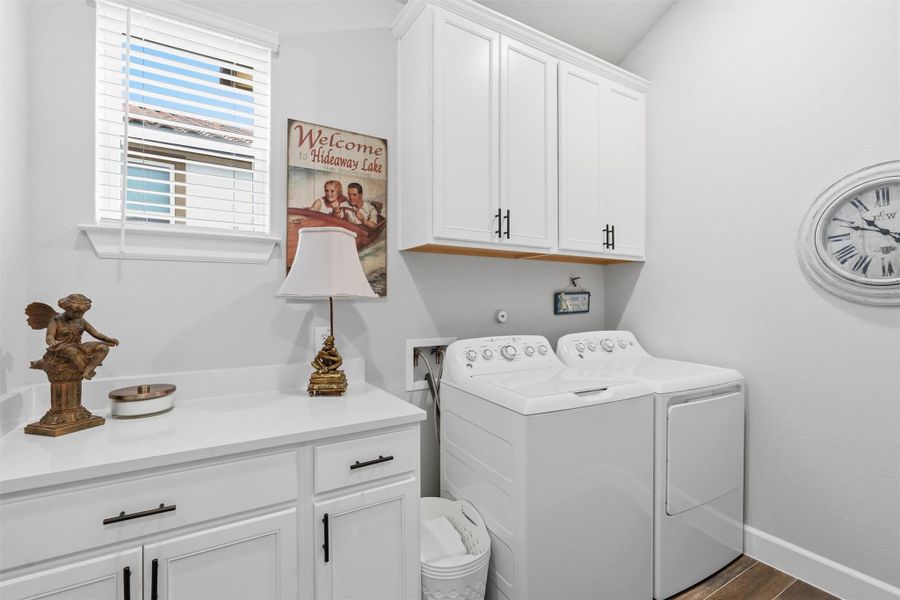 Beautiful laundry room with window, lower cabinets and folding area. Beautiful laundry room with window, lower cabinets and folding area.