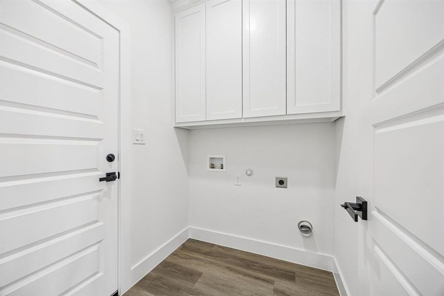 Laundry area with dryer & washer hookups and cabinet space