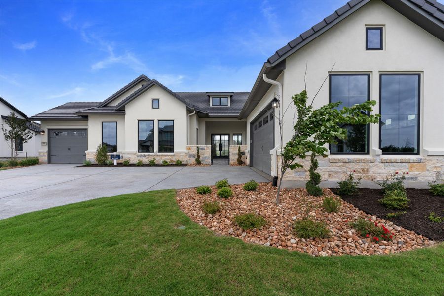 A modern facade with striking stucco and stone accents greets visitors with a contemporary flair.