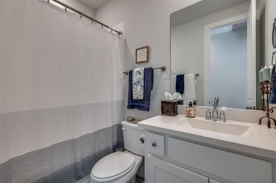 Full bath with vanity and a shower with curtain