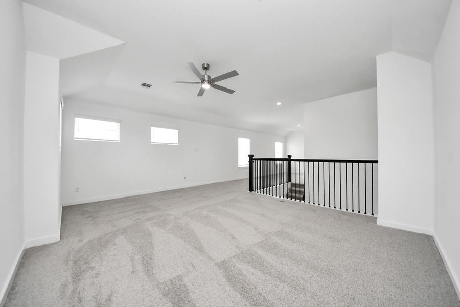 Ascend to relaxation in this fantastic game room! Ideal for both casual gatherings and adult gaming, it boasts plush carpet, lofty ceilings, custom paint, and ample windows for abundant natural light. Sample photo of completed home with similar floor plan. Actual colors and selections may vary. Ascend to relaxation in this fantastic game room! Ideal for both casual gatherings and adult gaming, it boasts plush carpet, lofty ceilings, custom paint, and ample windows for abundant natural light. Sample photo of completed home with similar floor plan. Actual colors and selections may vary.