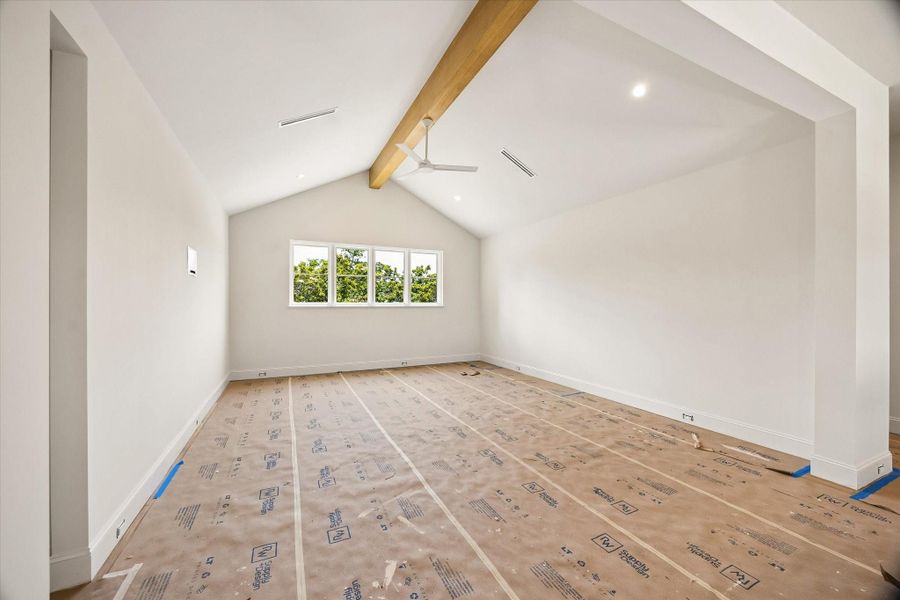 Upstairs Game Room with cathedral ceiling and white oak beam. The home offers white oak hardwood floors throughout the second floor. This home to include upgrade linear ac vents in first floor and upstairs game room.