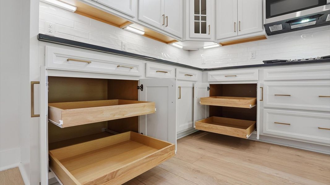 Exclusive kitchen design with abundant storage, white cabinets, and tasteful finishes throughout located in Greenville, SC