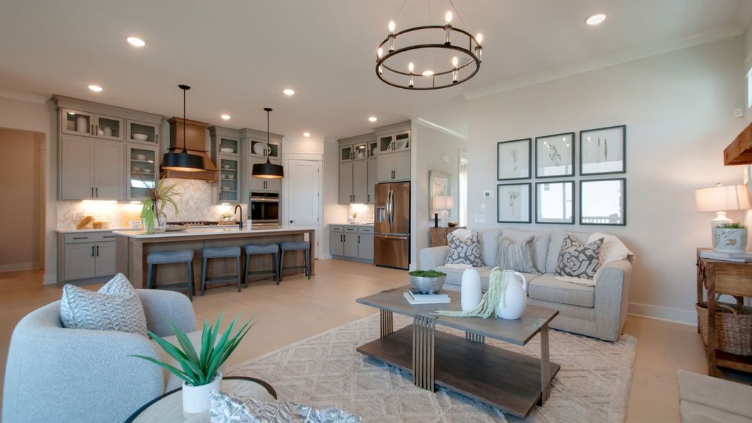 Gathering room with connecting kitchen/dining area and large glass sliding doors out to the covered outdoor patio space Gathering room with connecting kitchen/dining area and large glass sliding doors out to the covered outdoor patio space