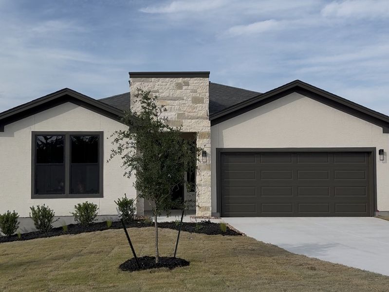 Front exterior of a new home in The Summit, San Antonio, TX, highlighting curb appeal (Image 1). Front exterior of a new home in The Summit, San Antonio, TX, highlighting curb appeal (Image 1).
