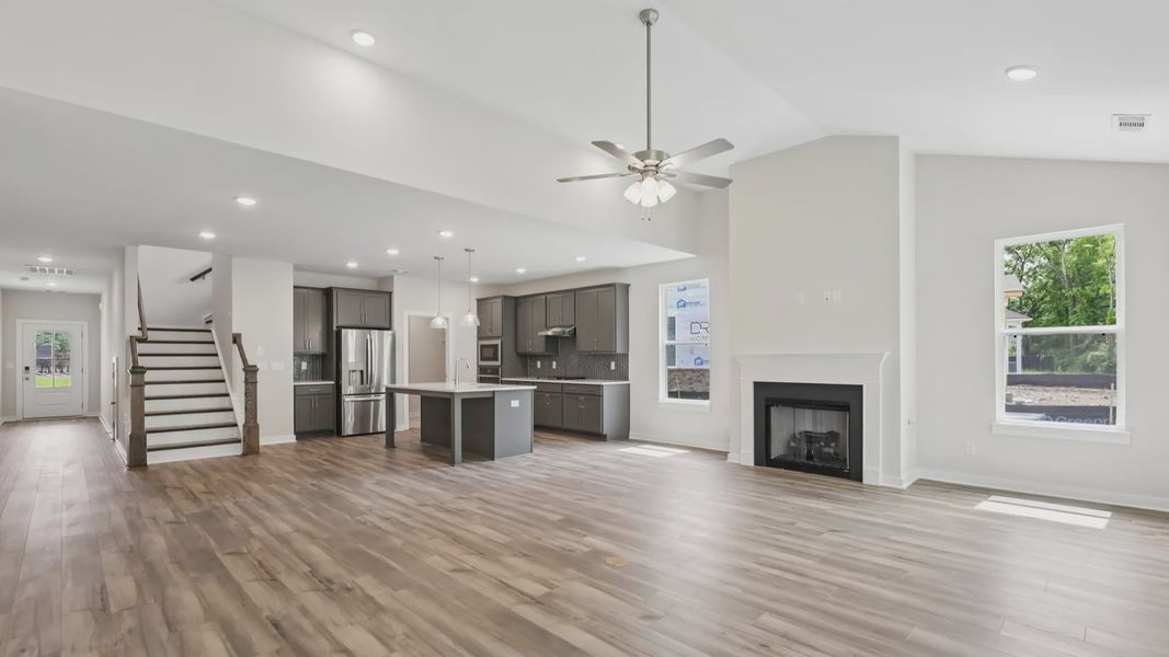 View of kitchen, gathering room, and staircase