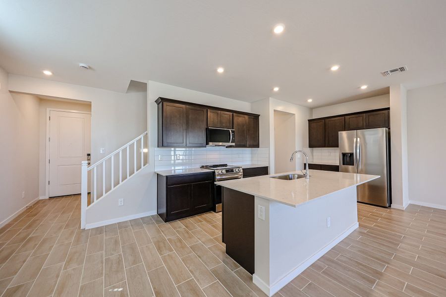A kitchen with wooden cabinets. A kitchen with wooden cabinets.
