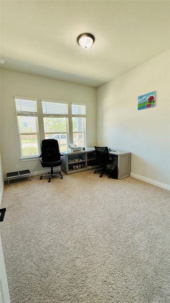 A versatile office space provides abundant natural light, creating an ideal work-from-home environment.