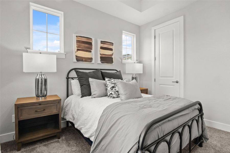 Bedroom featuring baseboards and carpet floors Bedroom featuring baseboards and carpet floors