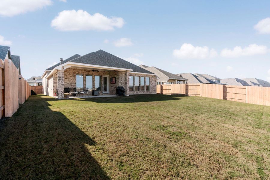 Exterior details and patio area of a home in The Colony, Bastrop (Image 21).