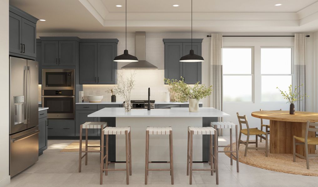 Kitchen with pendant lighting and stainless steel hood