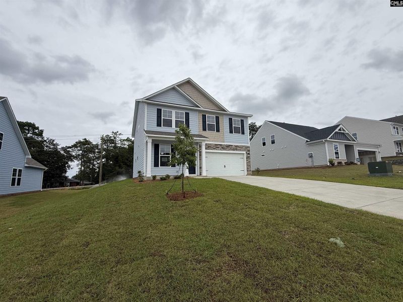 Front exterior of a new home in Cottages at Roofs Pond, West Columbia, SC, highlighting curb appeal (Image 25).