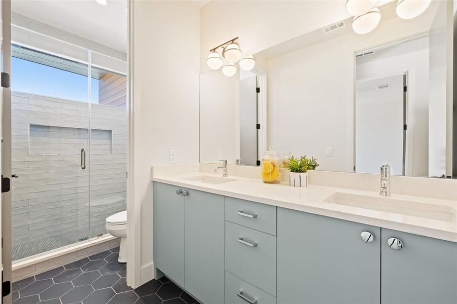 The full guest bath on the second floor exudes contemporary elegance, providing a stylish and comfortable space for visitors to unwind and refresh.