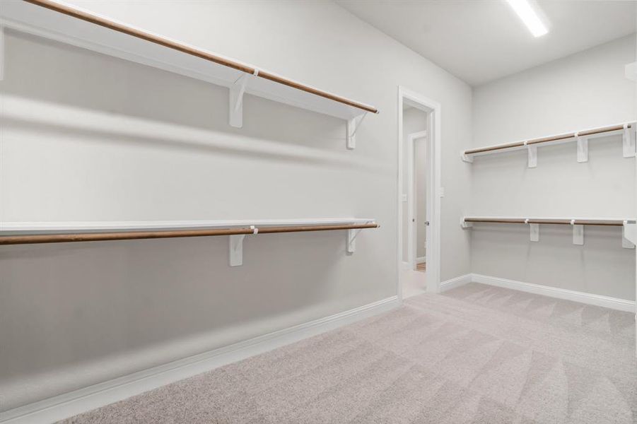 Huge walk-in closet with custom built-ins.