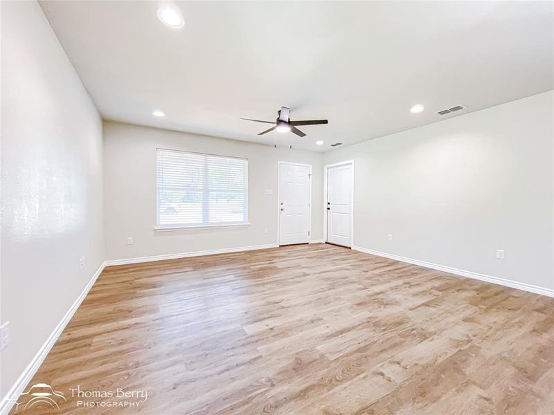 Empty room with light wood-style flooring, recessed lighting, and a ceiling fan Empty room with light wood-style flooring, recessed lighting, and a ceiling fan