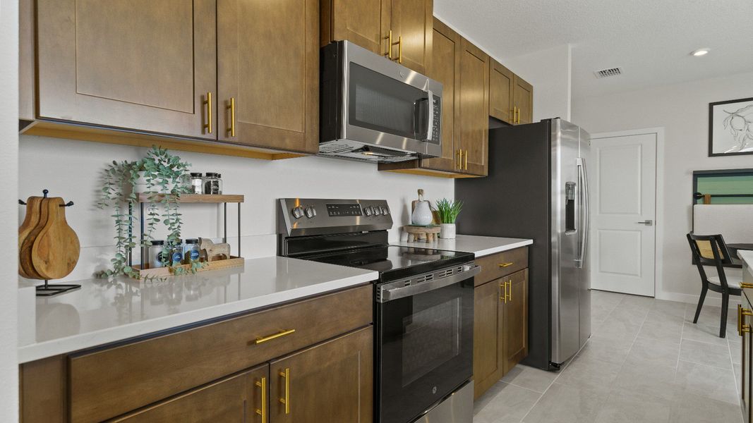 The Atlantic kitchen with full appliances and warm wood cabinetry, perfect for daily cooking and entertaining.