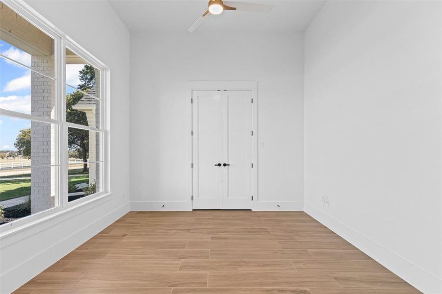 Spare room featuring wood finish floors and ceiling fan