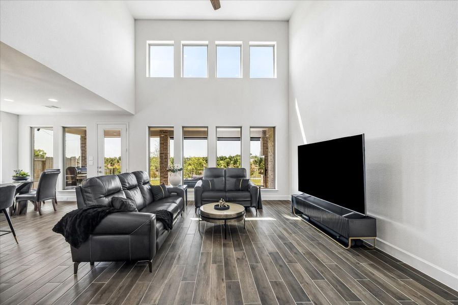 Wall of windows and soaring two-story ceilings fill the family room with abundant natural light