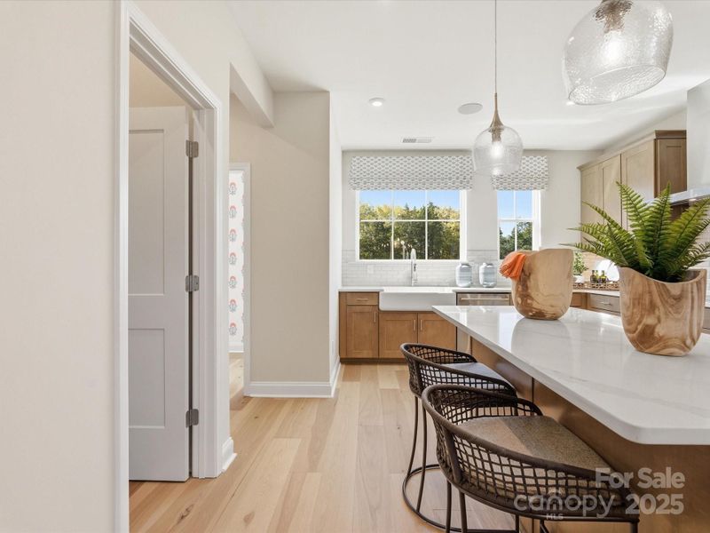 Large Central Island Ideal for Entertaining. *Model Photos | Actual Finishes, Structural Selections, and Orientation May Vary.