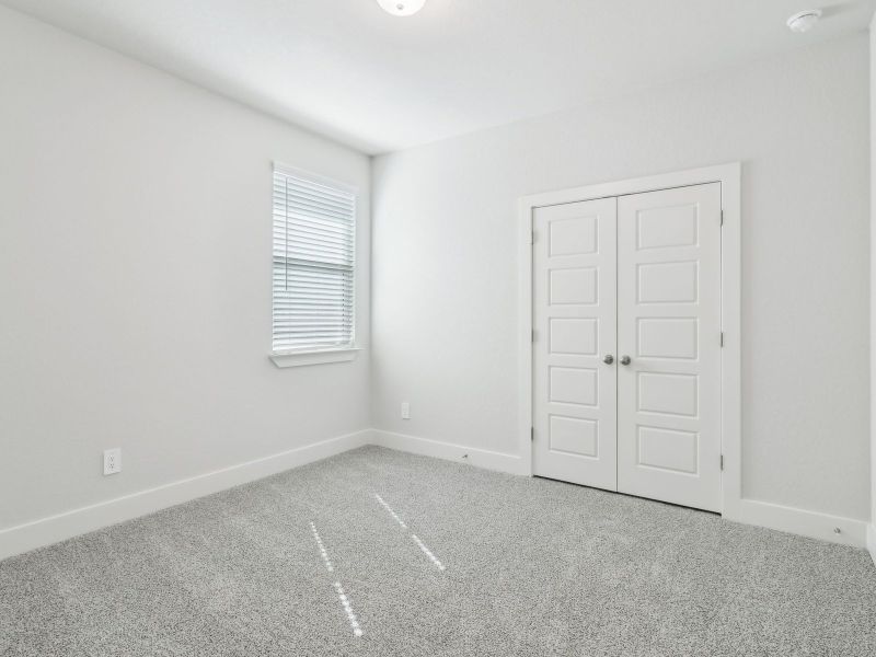 Guest bedroom in the San Saba floorplan at a Meritage Homes community.