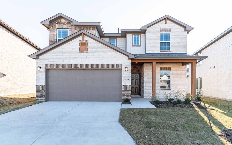 Front exterior of a new home in Travis Ranch, Forney, TX, highlighting curb appeal (Image 1).