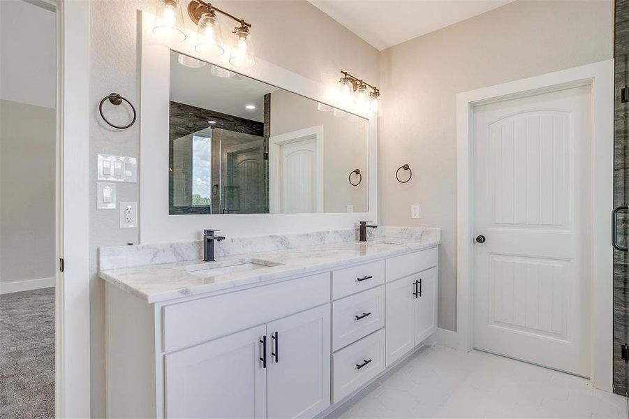 Bathroom featuring walk in shower and vanity