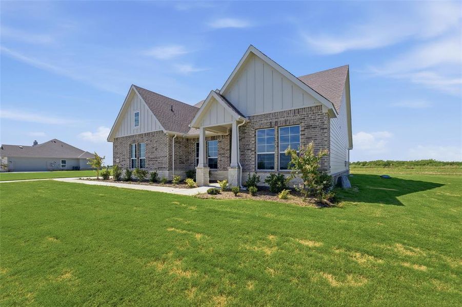 Single-story residence featuring a brick and horizontal siding exterior, a covered entry, gabled rooflines, and mature landscaping Single-story residence featuring a brick and horizontal siding exterior, a covered entry, gabled rooflines, and mature landscaping