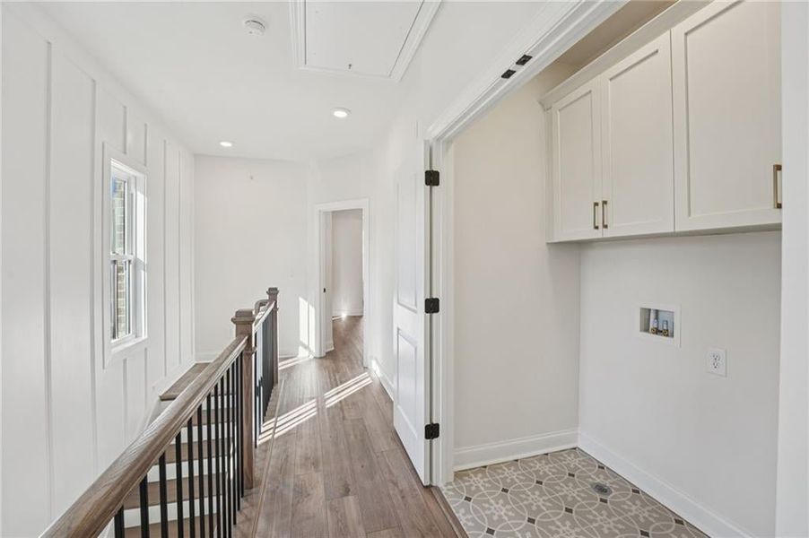 View of laundry closet from other side of hallway- with an End Unit- you may have windows which bring in tons of natural light in this upstairs hallway.  Image is of previously built home.