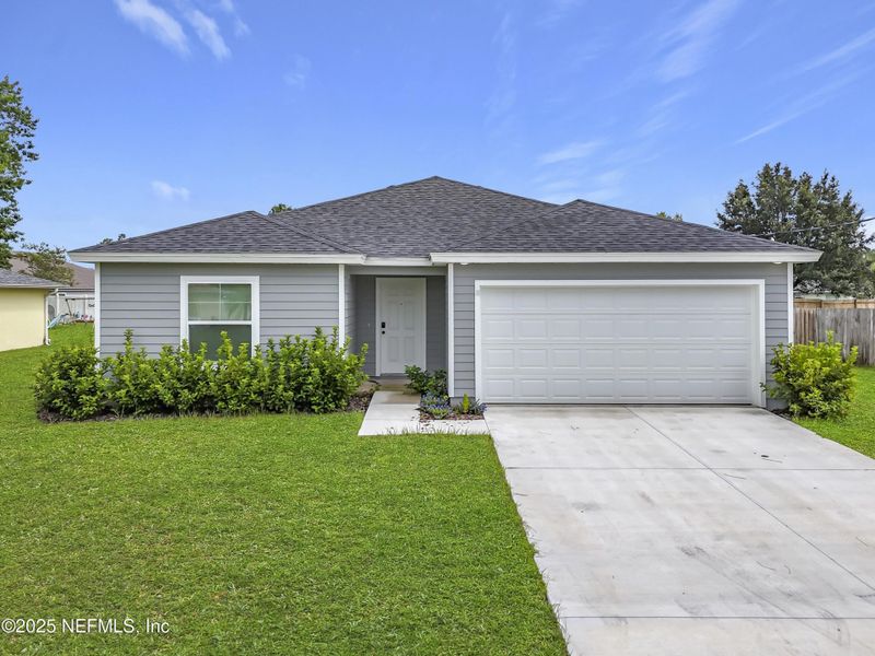 Front exterior of a new home in , Palm Coast, FL, highlighting curb appeal (Image 1). Front exterior of a new home in , Palm Coast, FL, highlighting curb appeal (Image 1).