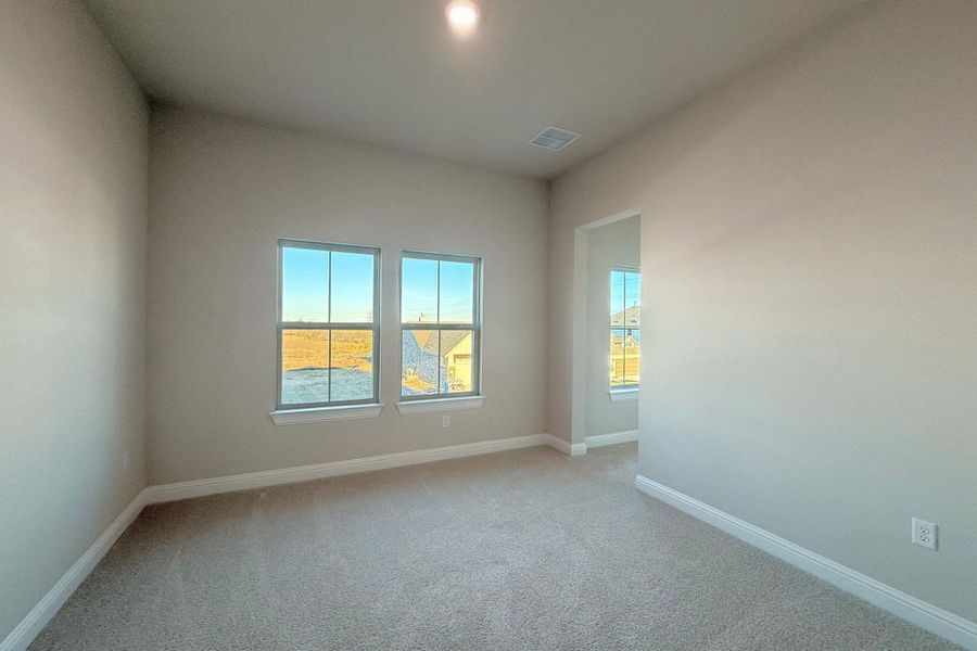 Unfurnished room featuring light colored carpet and baseboards