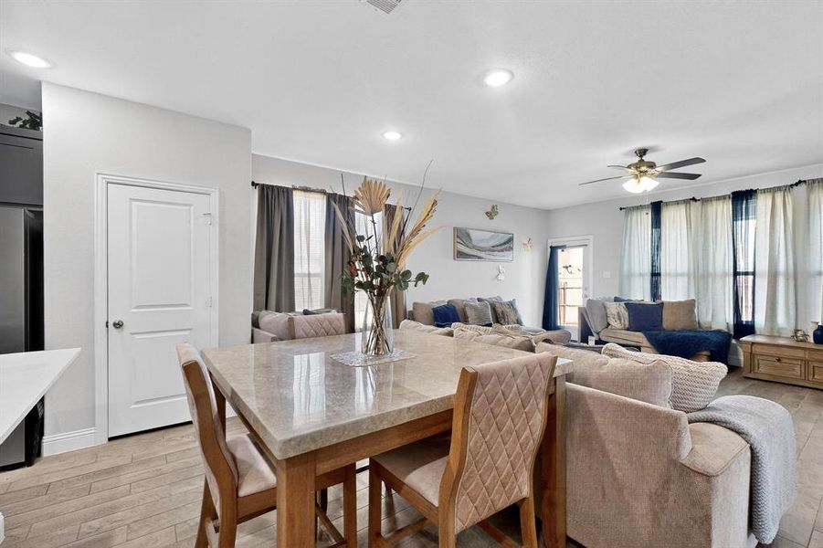 Dining area with recessed lighting, a ceiling fan, and light wood-style floors Dining area with recessed lighting, a ceiling fan, and light wood-style floors