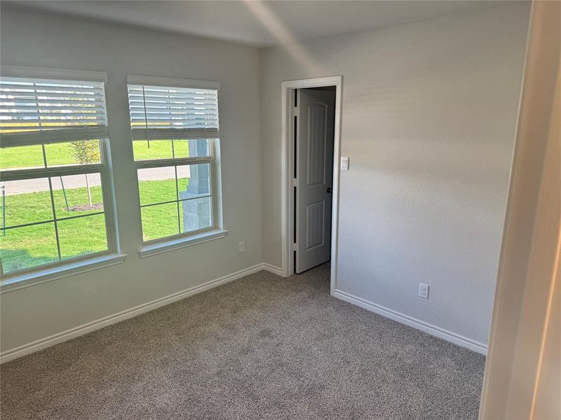 Carpeted empty room featuring baseboards Carpeted empty room featuring baseboards