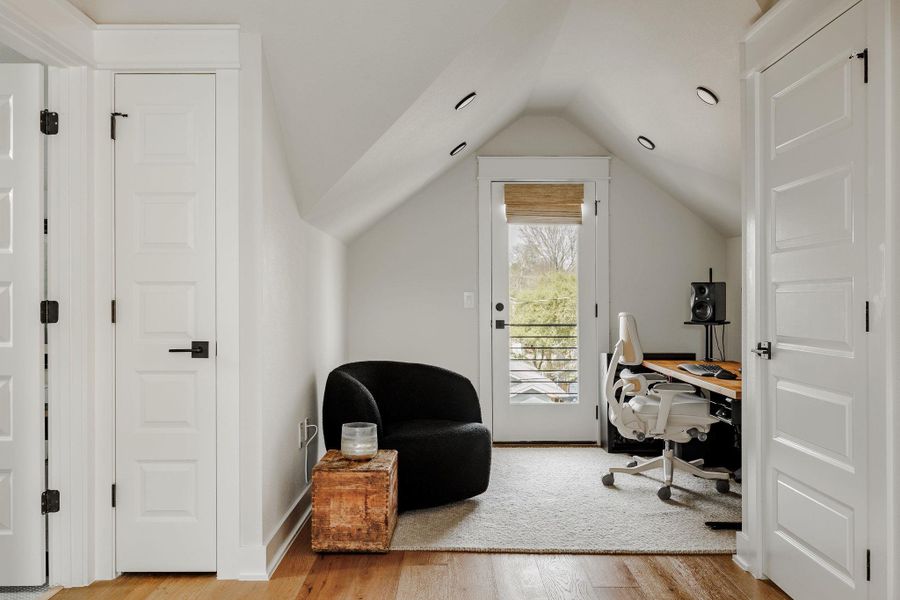 Office with light wood-style floors and baseboards