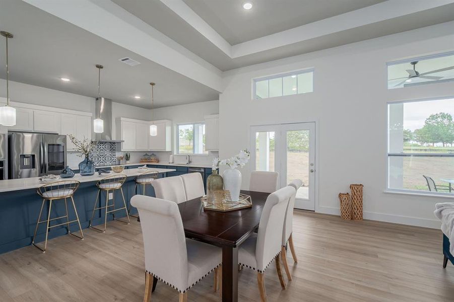 Dining room featuring light hardwood / wood-style flooring, ceiling fan, and sink