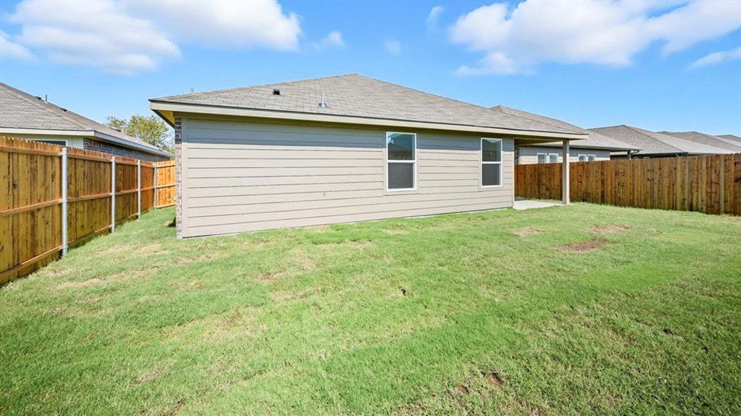 Back of house featuring roof with shingles, a fenced backyard, and a patio area Back of house featuring roof with shingles, a fenced backyard, and a patio area