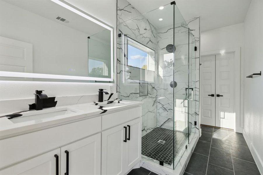 Bathroom with vanity, tile patterned floors, and an enclosed shower