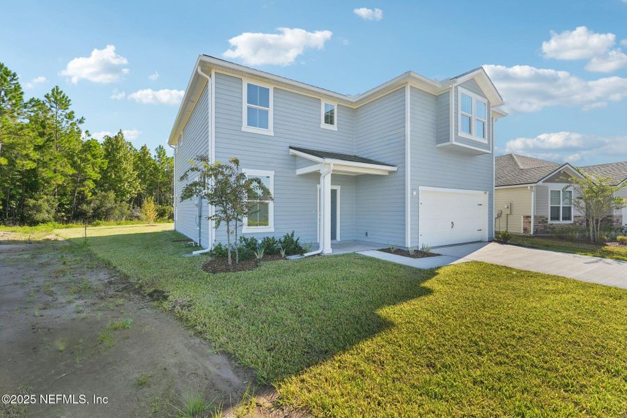 Front exterior of a new home in Panther Creek, Jacksonville, FL, highlighting curb appeal (Image 22).