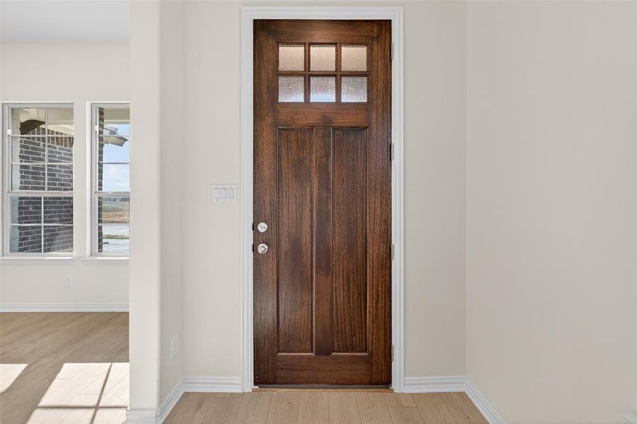 Foyer entrance with healthy amount of natural light and light wood finished floors