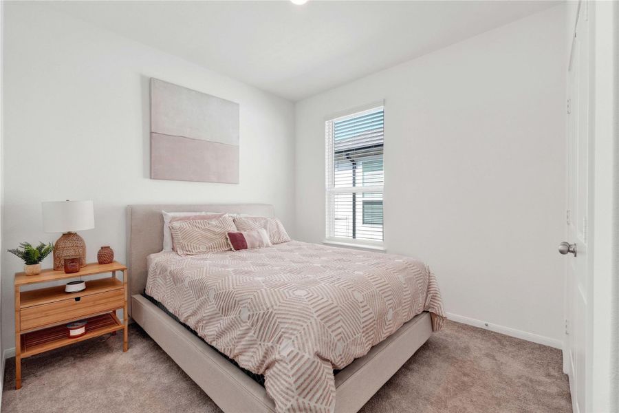 The secondary bedrooms are bright and versatile, ideal for guests, children, or a home office, complemented by a stylish full bathroom designed with modern finishes and thoughtful details.