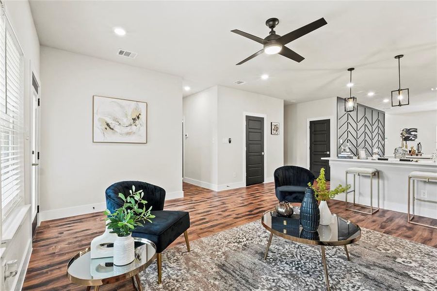 Living area with recessed lighting, ceiling fan, and dark wood-style floors Living area with recessed lighting, ceiling fan, and dark wood-style floors