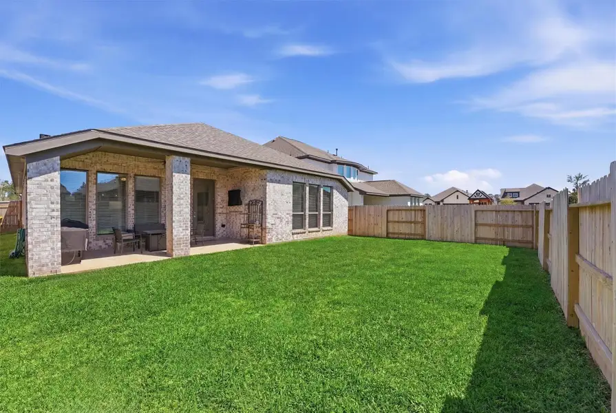 Fenced backyard with patio