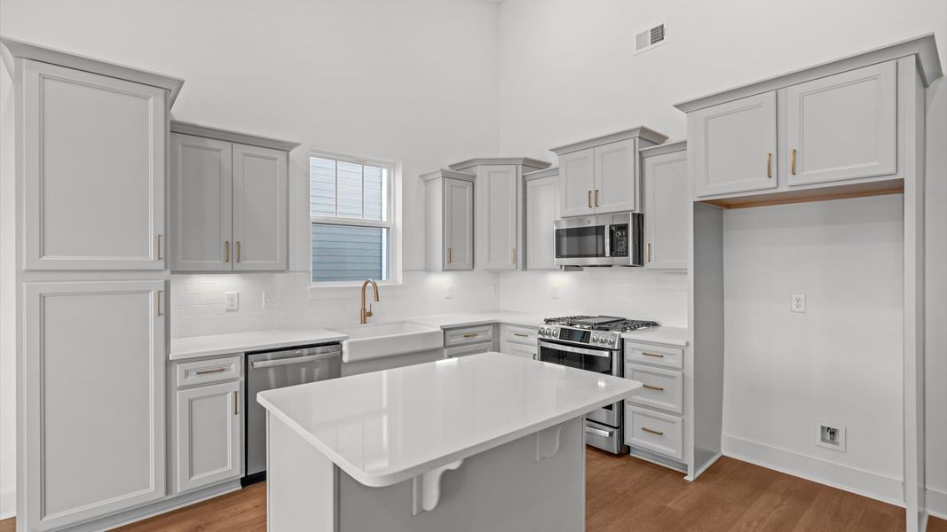 Highly functional kitchen offering a refined look and practical island at the center