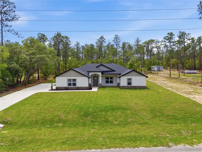 Front exterior of a new home in , Ocala, FL, highlighting curb appeal (Image 24).
