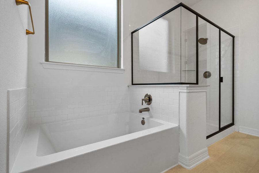 The primary is outfitted with a separate soaking tub and standing shower.