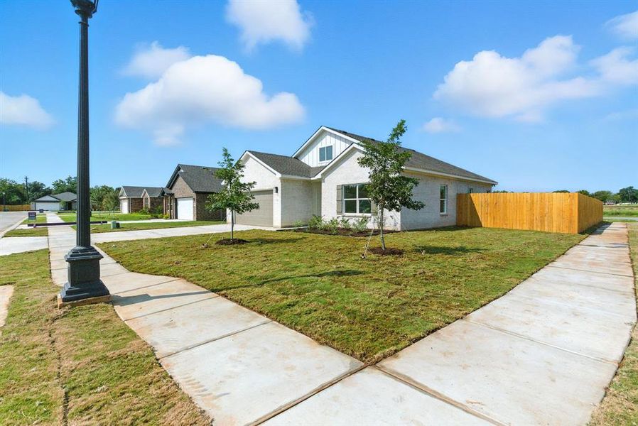 Front exterior of a new home in , Springtown, TX, highlighting curb appeal (Image 21).