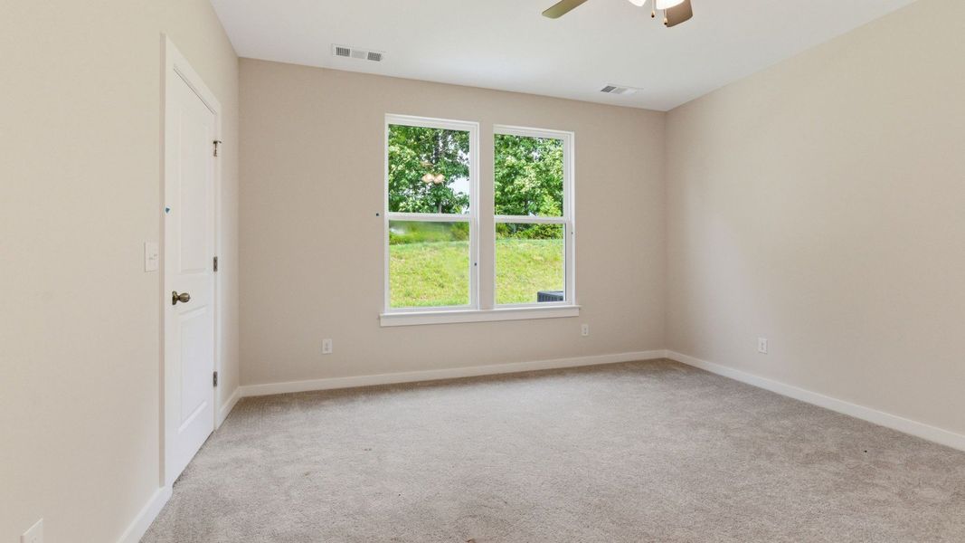 Bedroom with carpet and windows