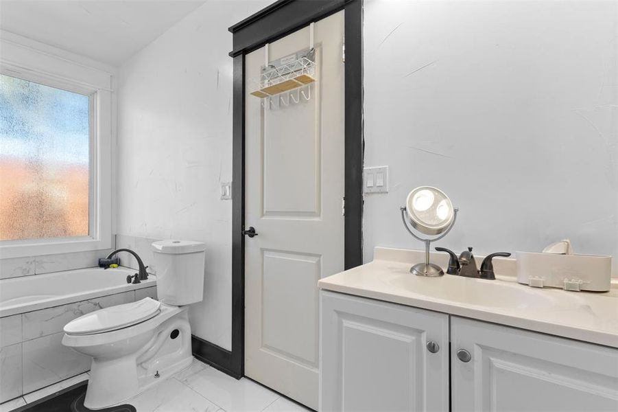 Full bath with vanity and a garden tub Full bath with vanity and a garden tub