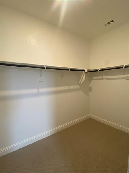Primary bedroom walk-in closet
